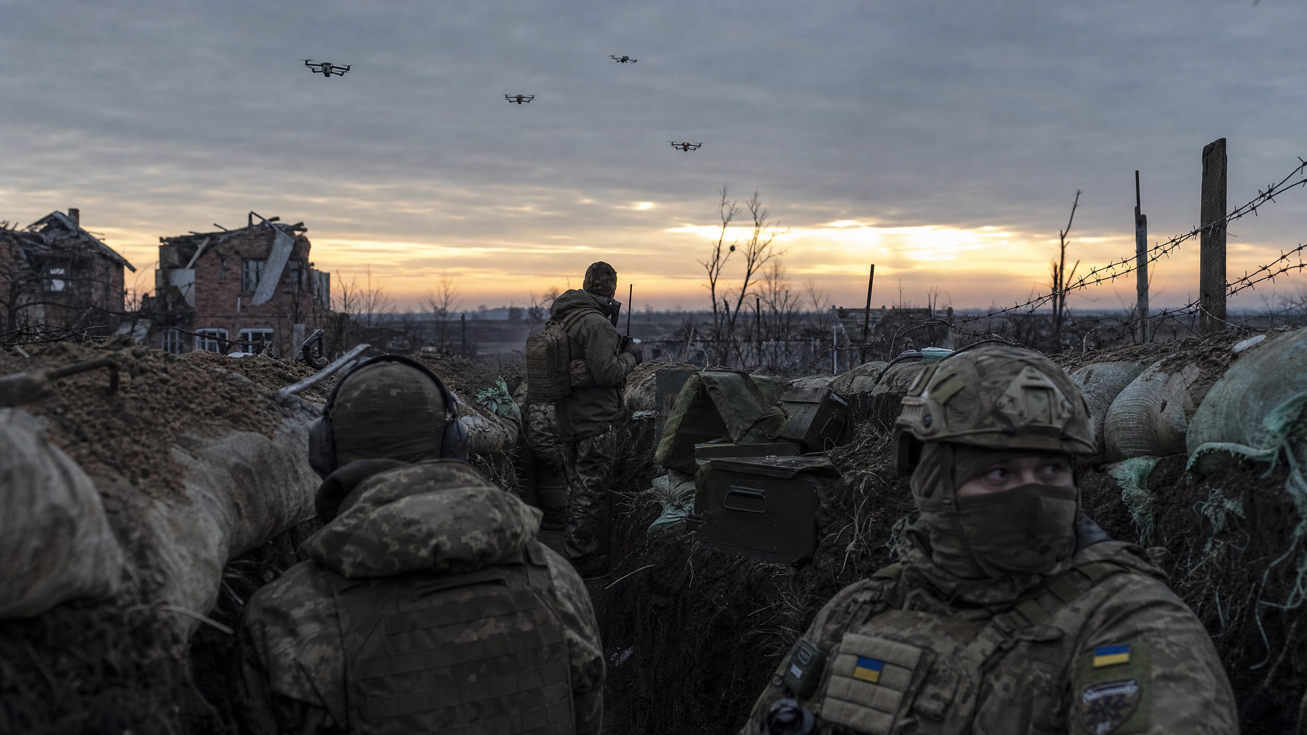Ukrainian soldiers near fortified positions with drone warfare equipment amid a contested ceasefire